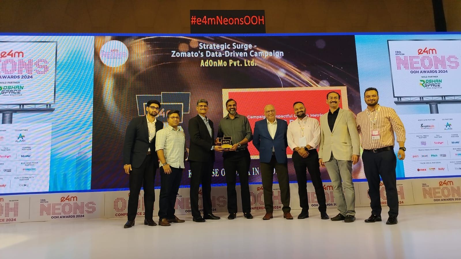 Adonmo Team receiving an award